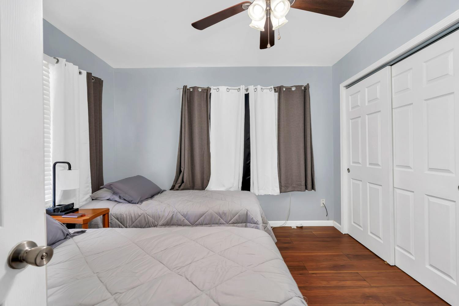 1164 J Street Reedley, CA 93654 - Photo 22 of 43 a bedroom with a bed and a chandelier