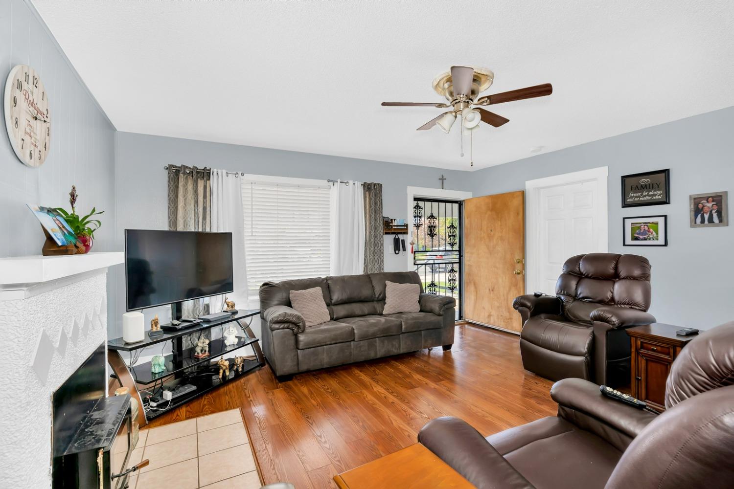 1164 J Street Reedley, CA 93654 - Photo 24 of 43 a living room with furniture and a flat screen tv