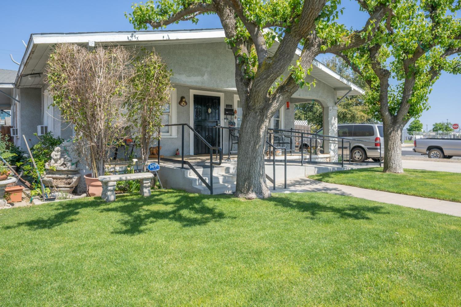 1164 J Street Reedley, CA 93654 - Photo 3 of 43 a view of a house with a yard porch and sitting area