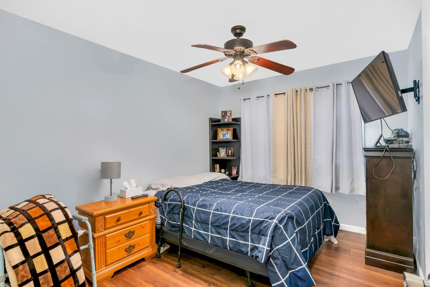 1164 J Street Reedley, CA 93654 - Photo 31 of 43 a bedroom with a bed and a chandelier