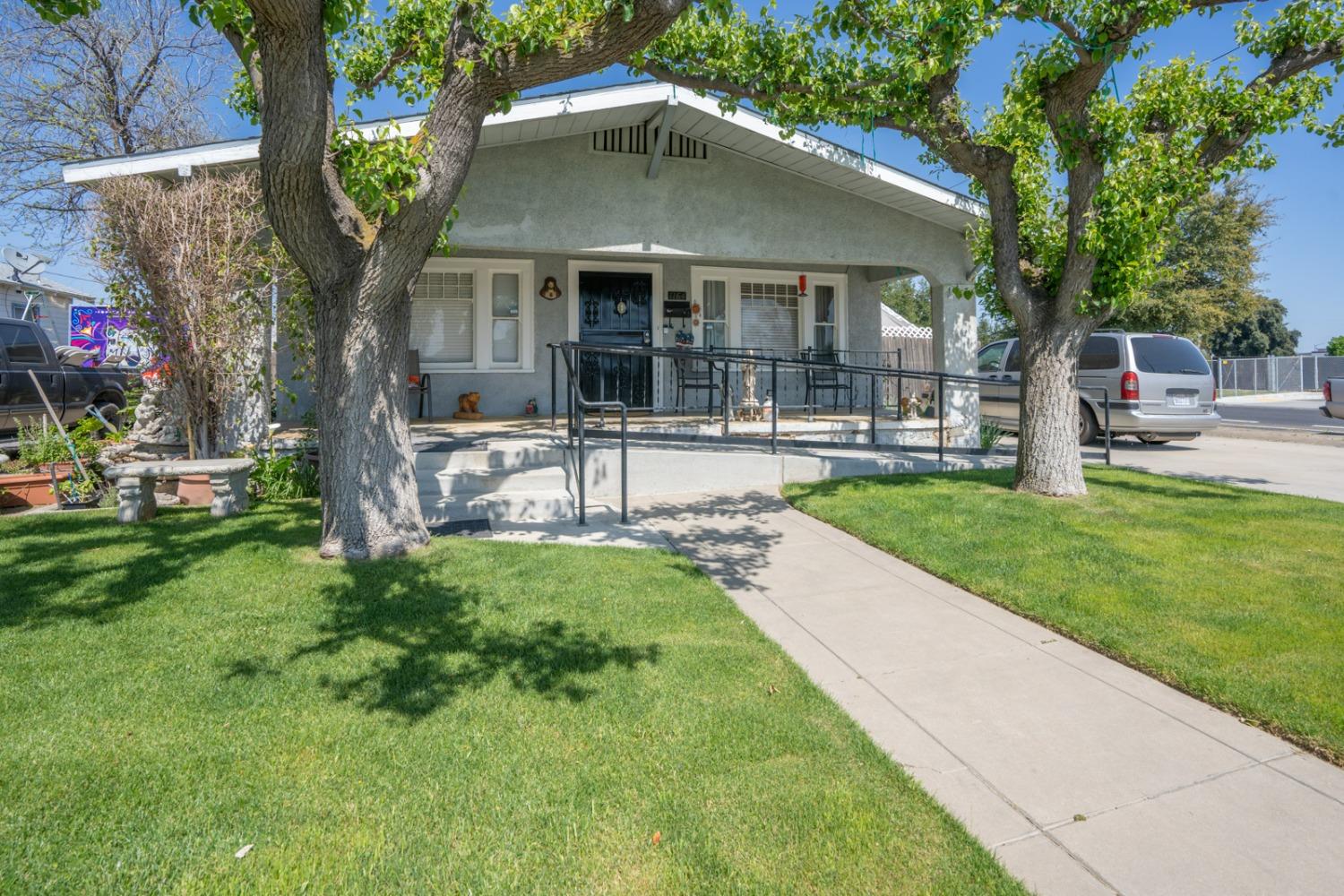 1164 J Street Reedley, CA 93654 - Photo 4 of 43 a front view of house with yard and outdoor seating