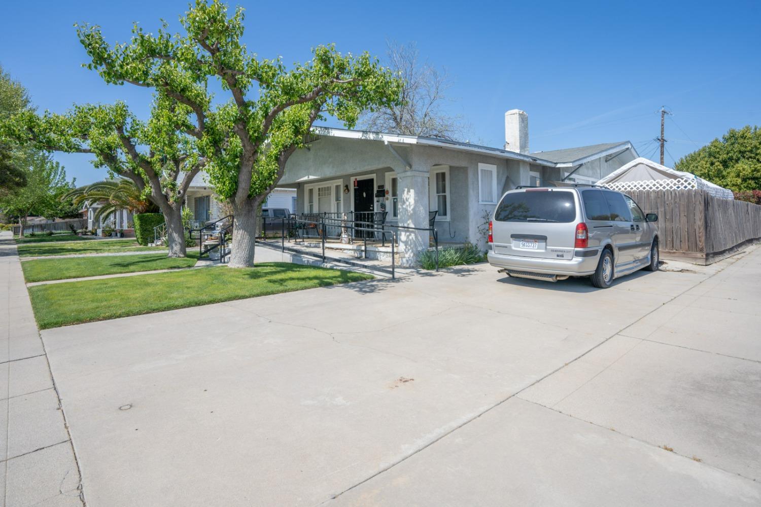1164 J Street Reedley, CA 93654 - Photo 5 of 43 a car parked in front of a house