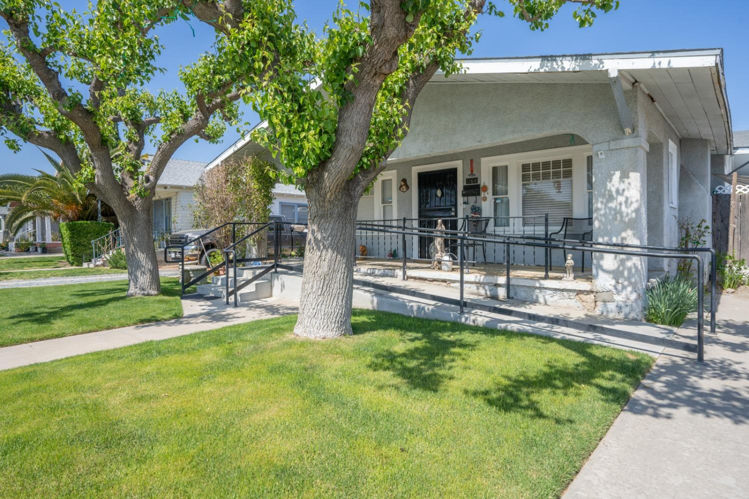 1164 J Street Reedley, CA 93654 - Photo 6 of 43 a view of house with a backyard porch and sitting area