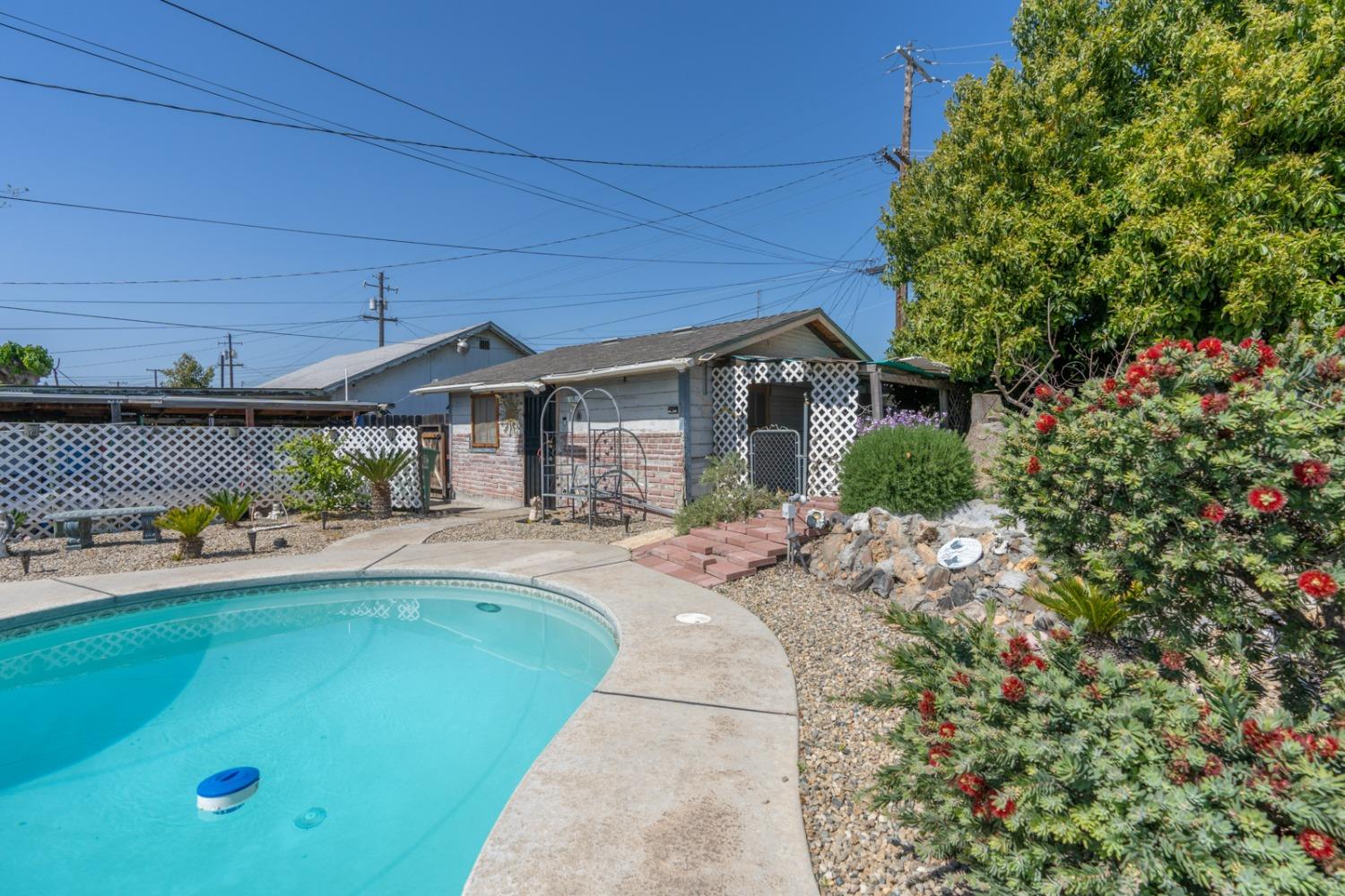 1164 J Street Reedley, CA 93654 - Photo 9 of 43 a view of a house with backyard and sitting area