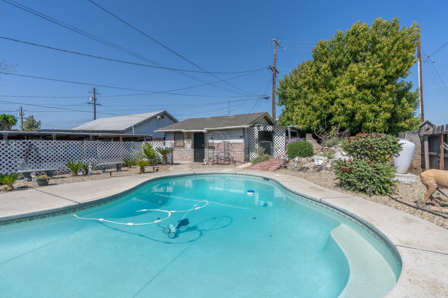 1164 J Street Reedley, CA 93654 - Photo 10 of 43 a house view with swimming pool and sitting space
