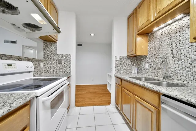 a kitchen with a sink stove and cabinets