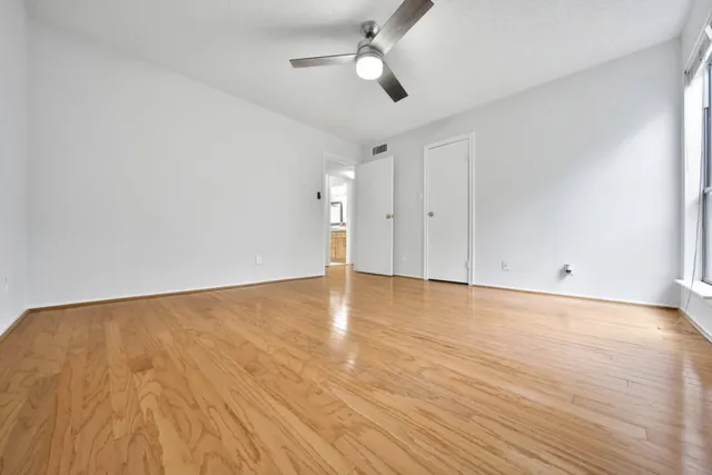 a view of an empty room and wooden floor