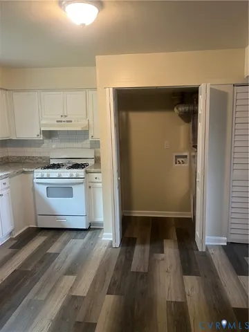 a kitchen with a stove a refrigerator and a sink