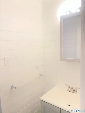 a bathroom with a white sink and vanity