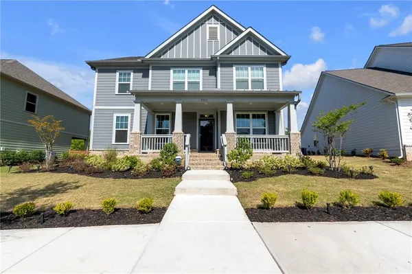 a front view of a house with swimming pool and porch