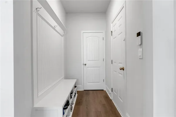 a view of a hallway with wooden floor
