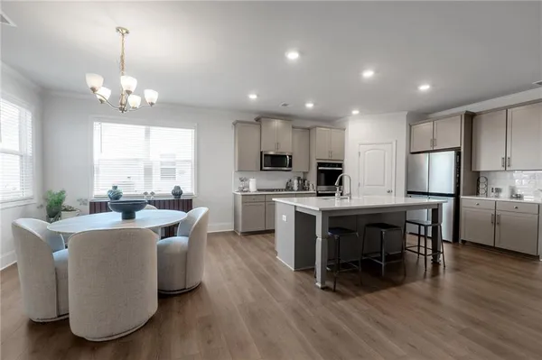 a kitchen with kitchen island granite countertop a center island stainless steel appliances cabinets and a center island
