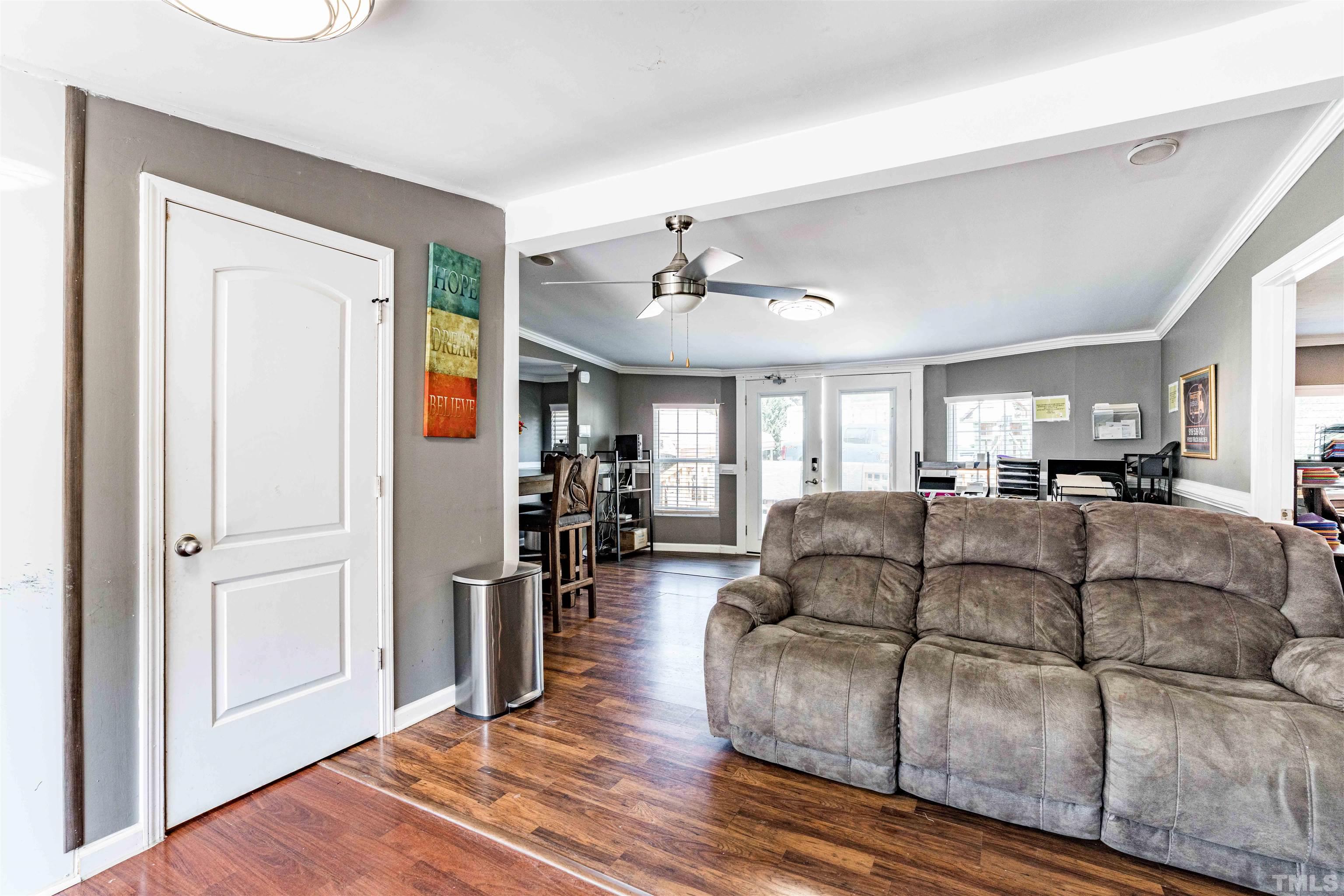 407 David Road Wendell, NC 27591 - Photo 11 of 39 a living room with furniture a ceiling fan and a window