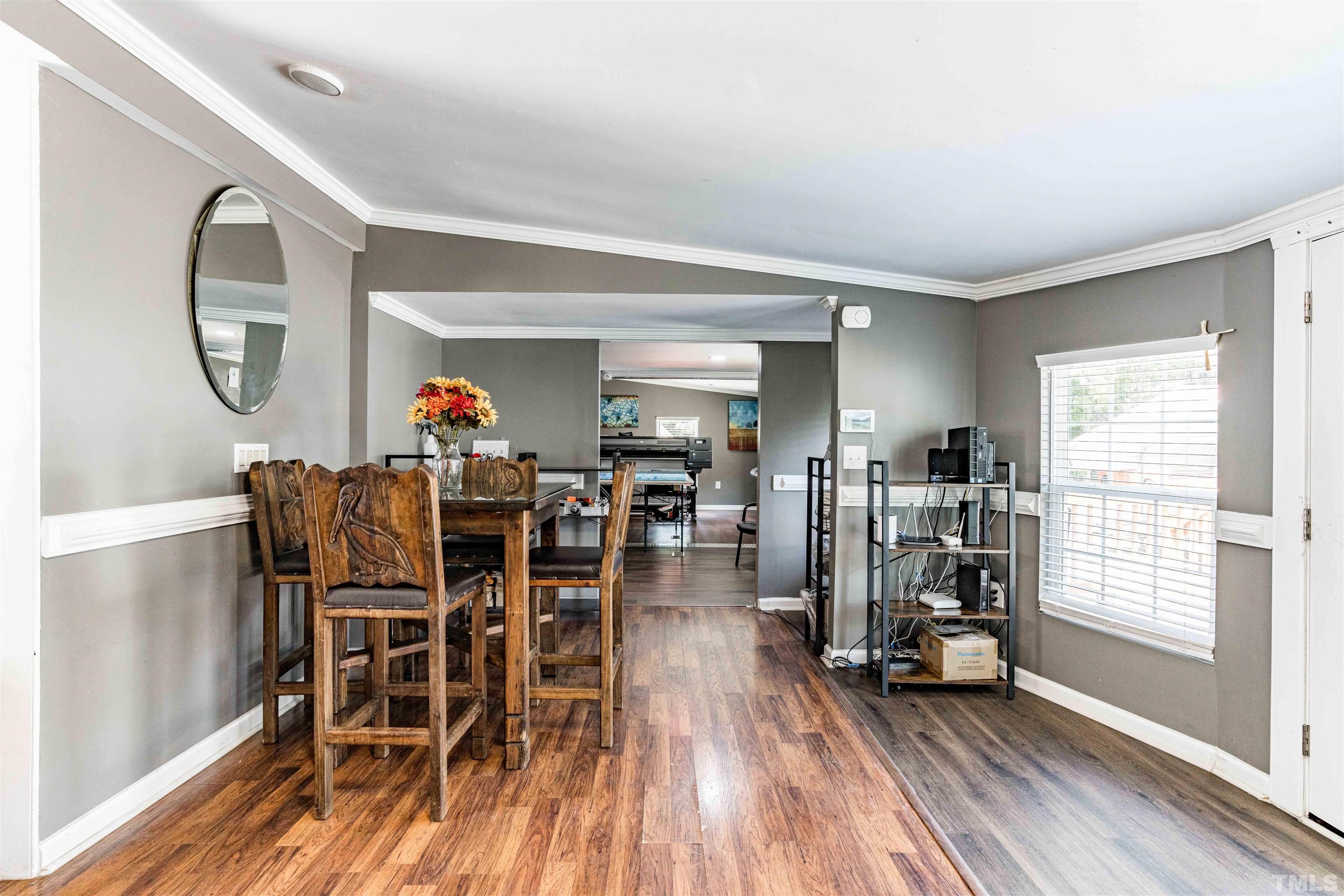407 David Road Wendell, NC 27591 - Photo 14 of 39 a view of a dining room with furniture window and wooden floor