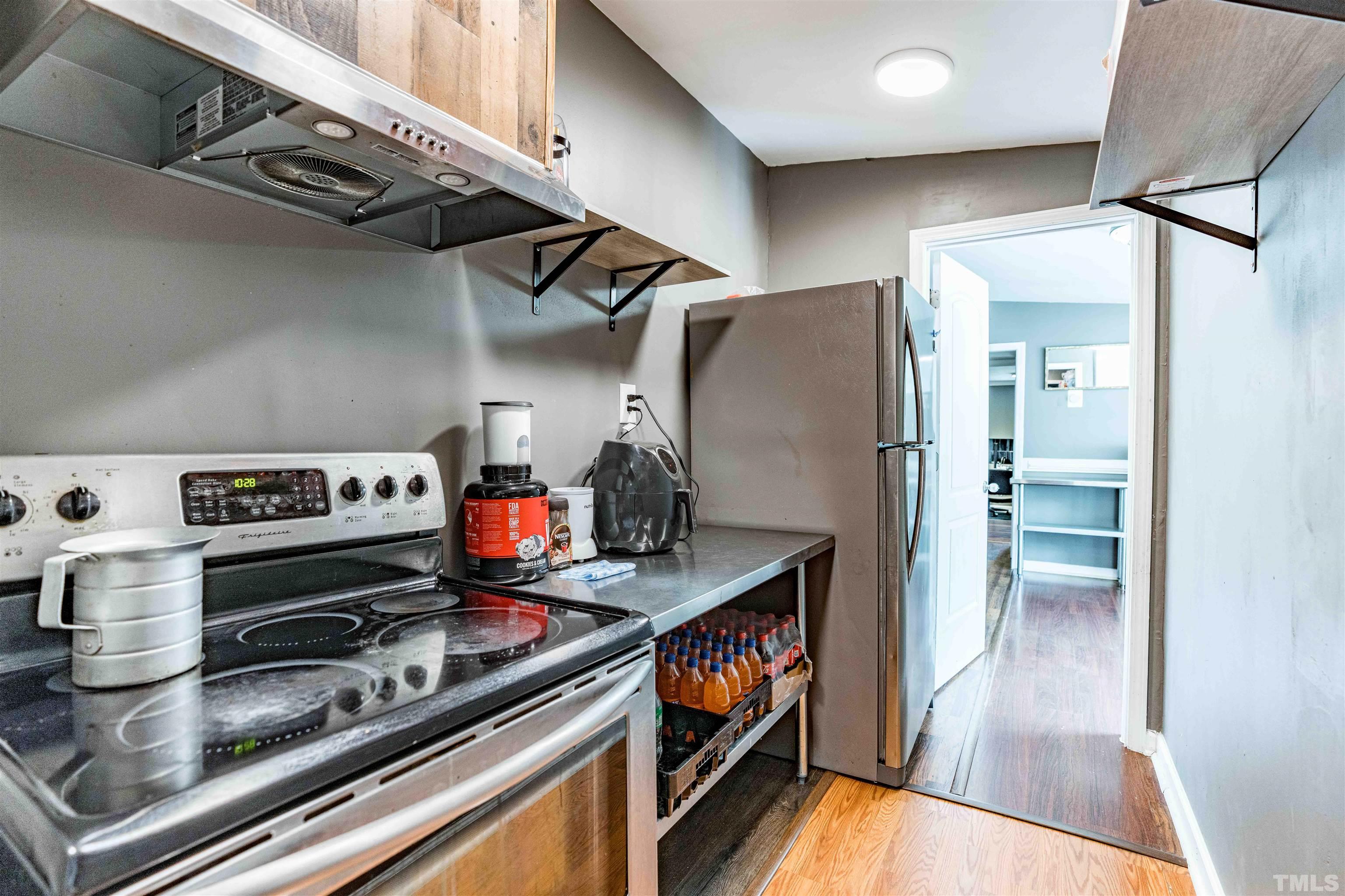 407 David Road Wendell, NC 27591 - Photo 19 of 39 a kitchen with stainless steel appliances granite countertop a refrigerator and a stove