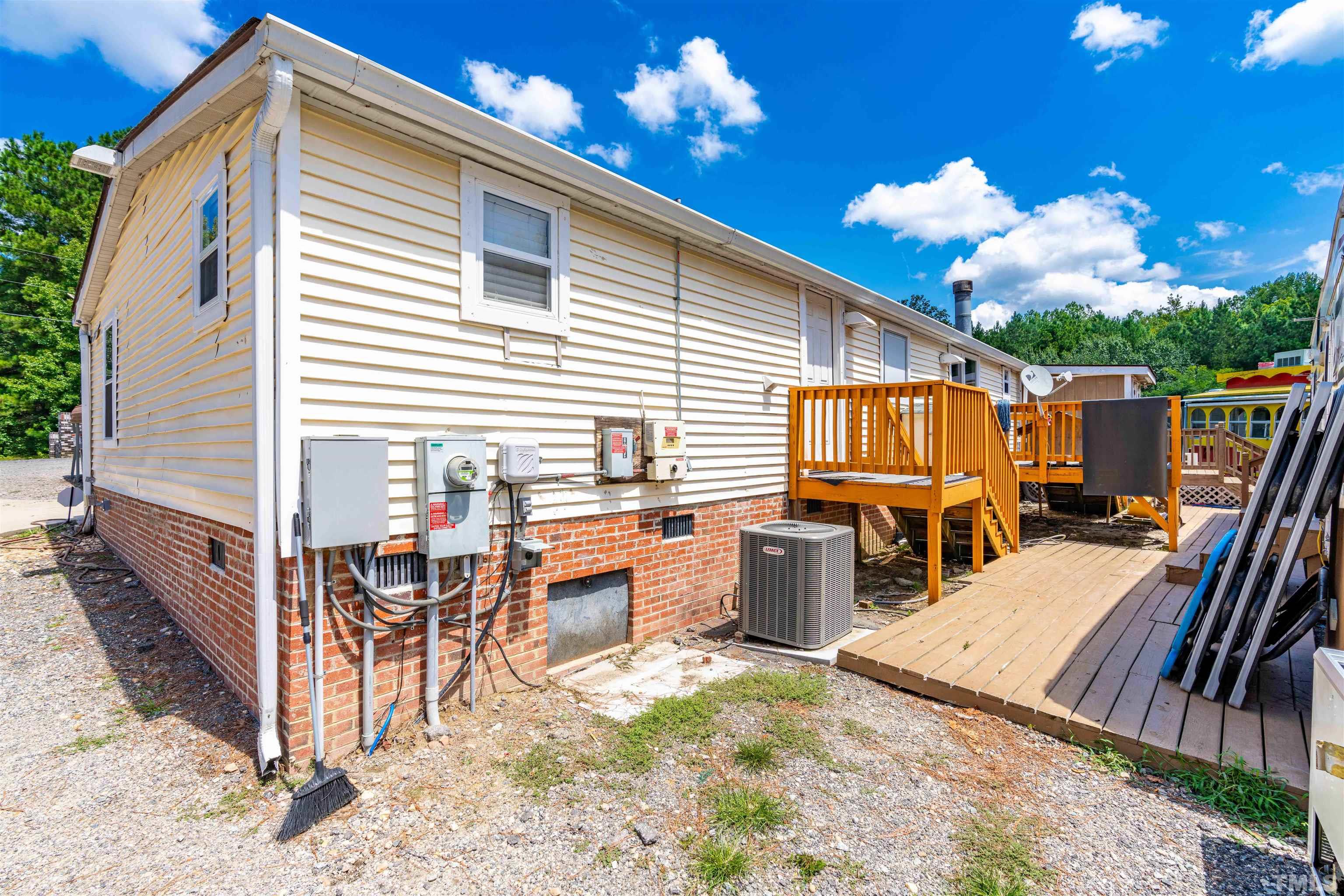 407 David Road Wendell, NC 27591 - Photo 32 of 39 a view of a patio with dining table and chairs with wooden floor