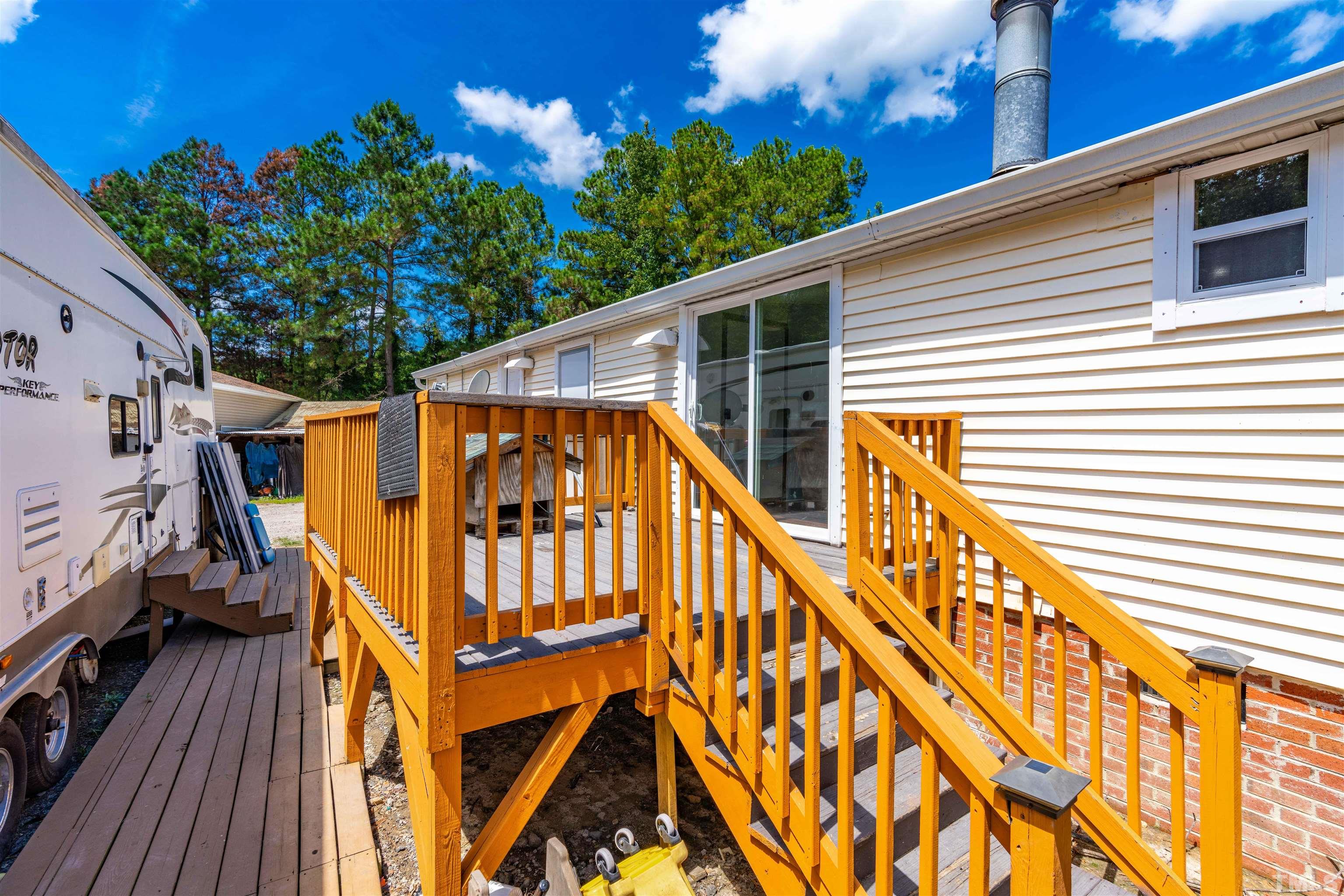 407 David Road Wendell, NC 27591 - Photo 33 of 39 a view of outdoor space with deck and wooden stairs