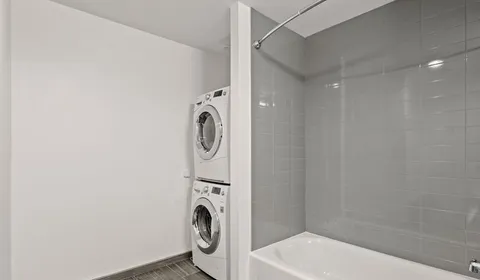 a bathroom with a sink a washer and dryer