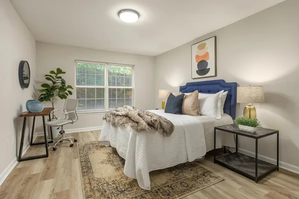 a bedroom with a bed and a large window