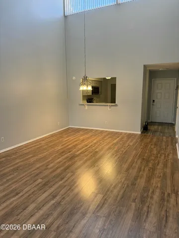 a view of a room with wooden floor