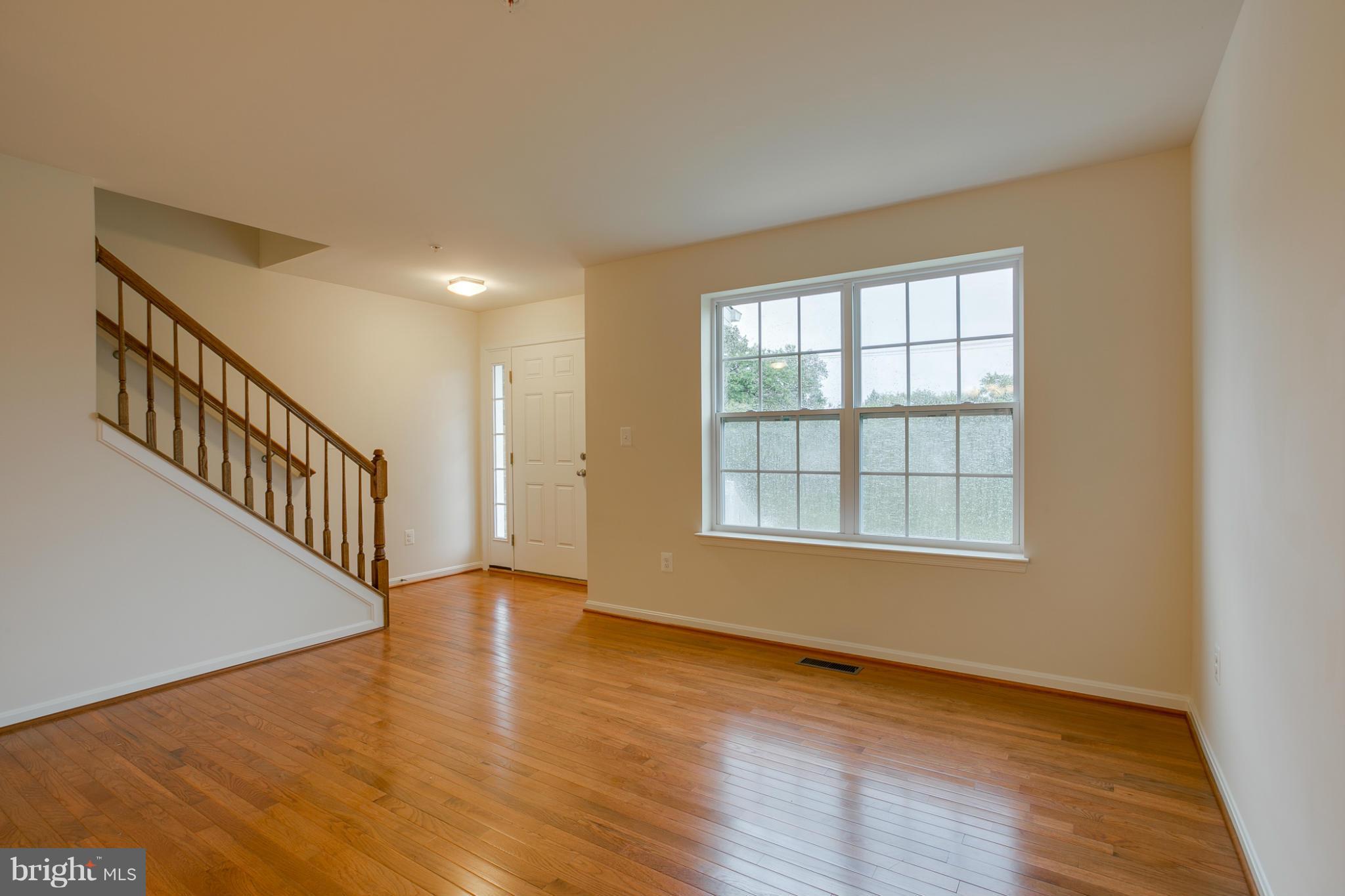 4 Hanover Road Hanover, MD 21076 - Photo 2 of 30 wooden floor in an empty room with a window