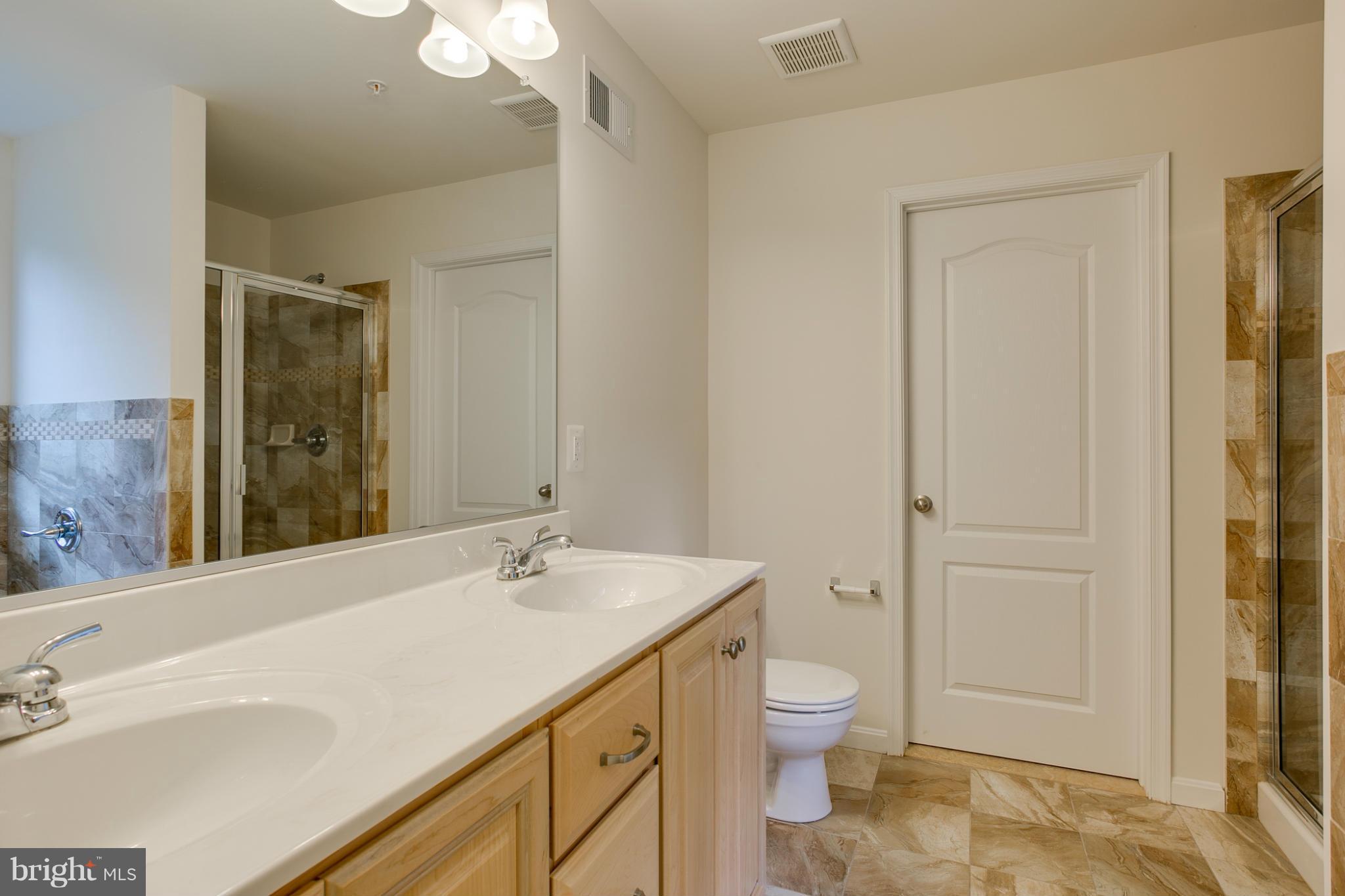 4 Hanover Road Hanover, MD 21076 - Photo 15 of 30 a bathroom with a sink a toilet and shower