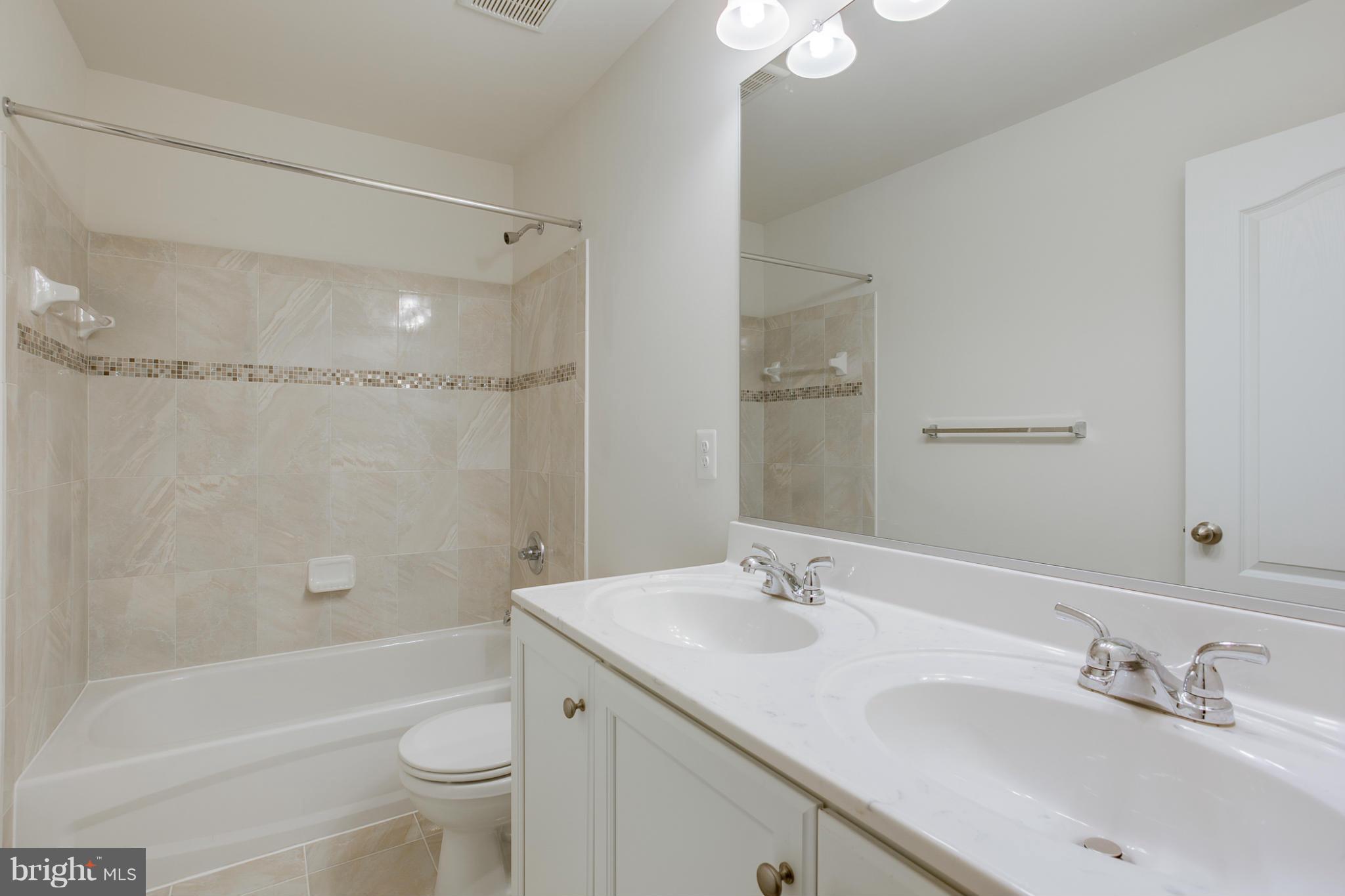4 Hanover Road Hanover, MD 21076 - Photo 16 of 30 a bathroom with a sink a toilet and shower