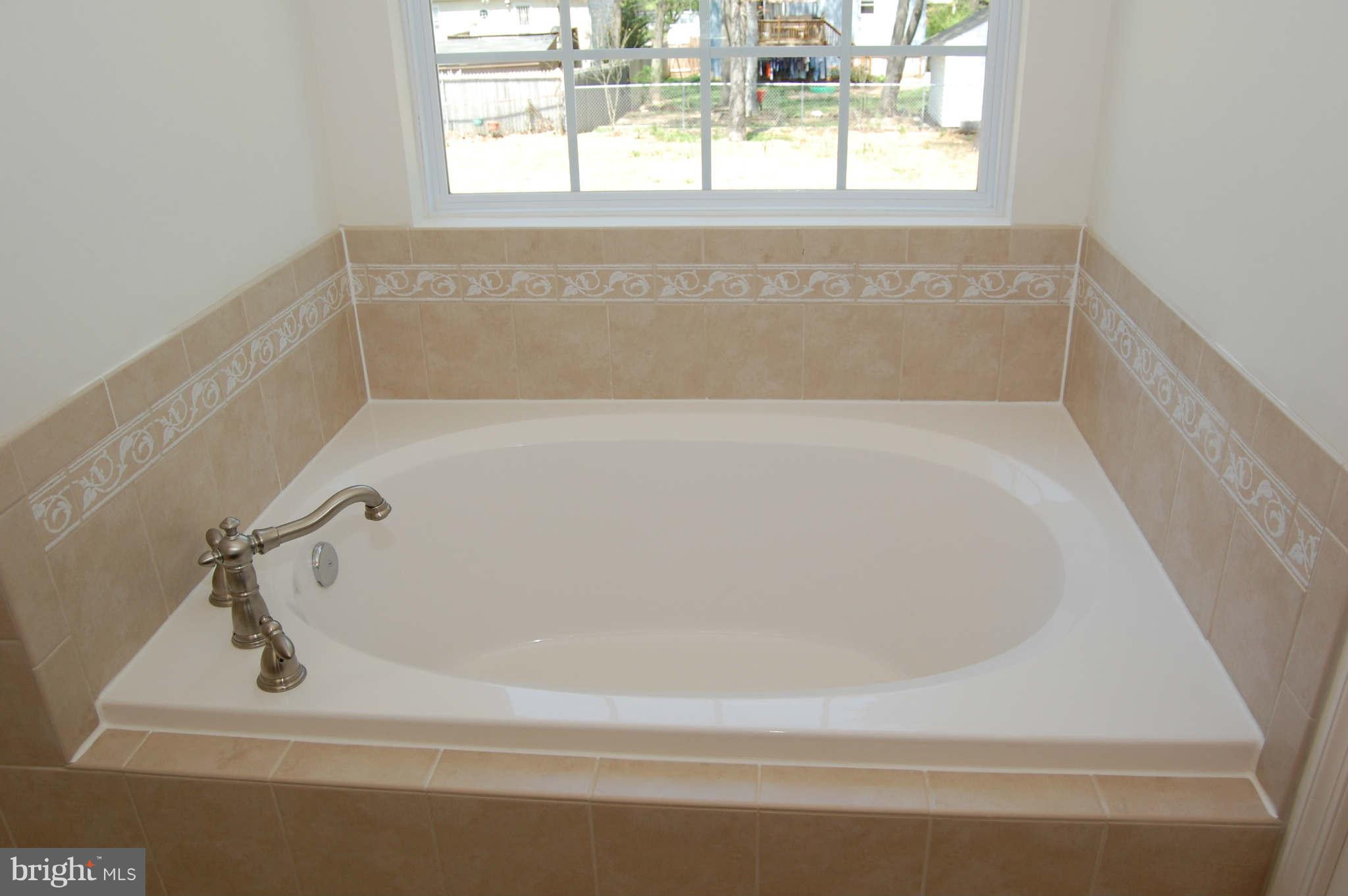 4 Hanover Road Hanover, MD 21076 - Photo 18 of 30 a white bath tub sitting next to a window