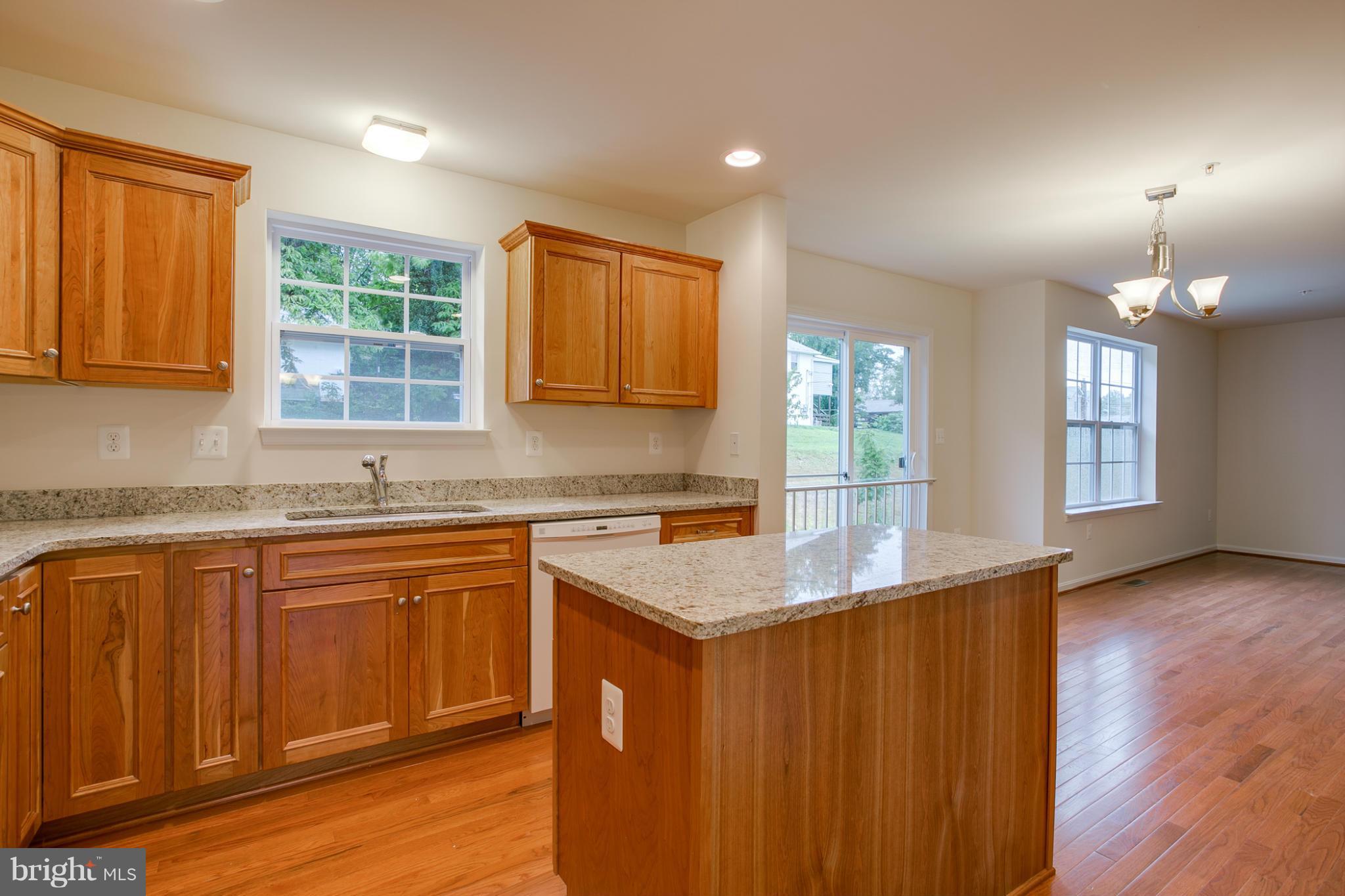 4 Hanover Road Hanover, MD 21076 - Photo 3 of 30 a kitchen with stainless steel appliances granite countertop wooden cabinets a sink and dishwasher with wooden floor