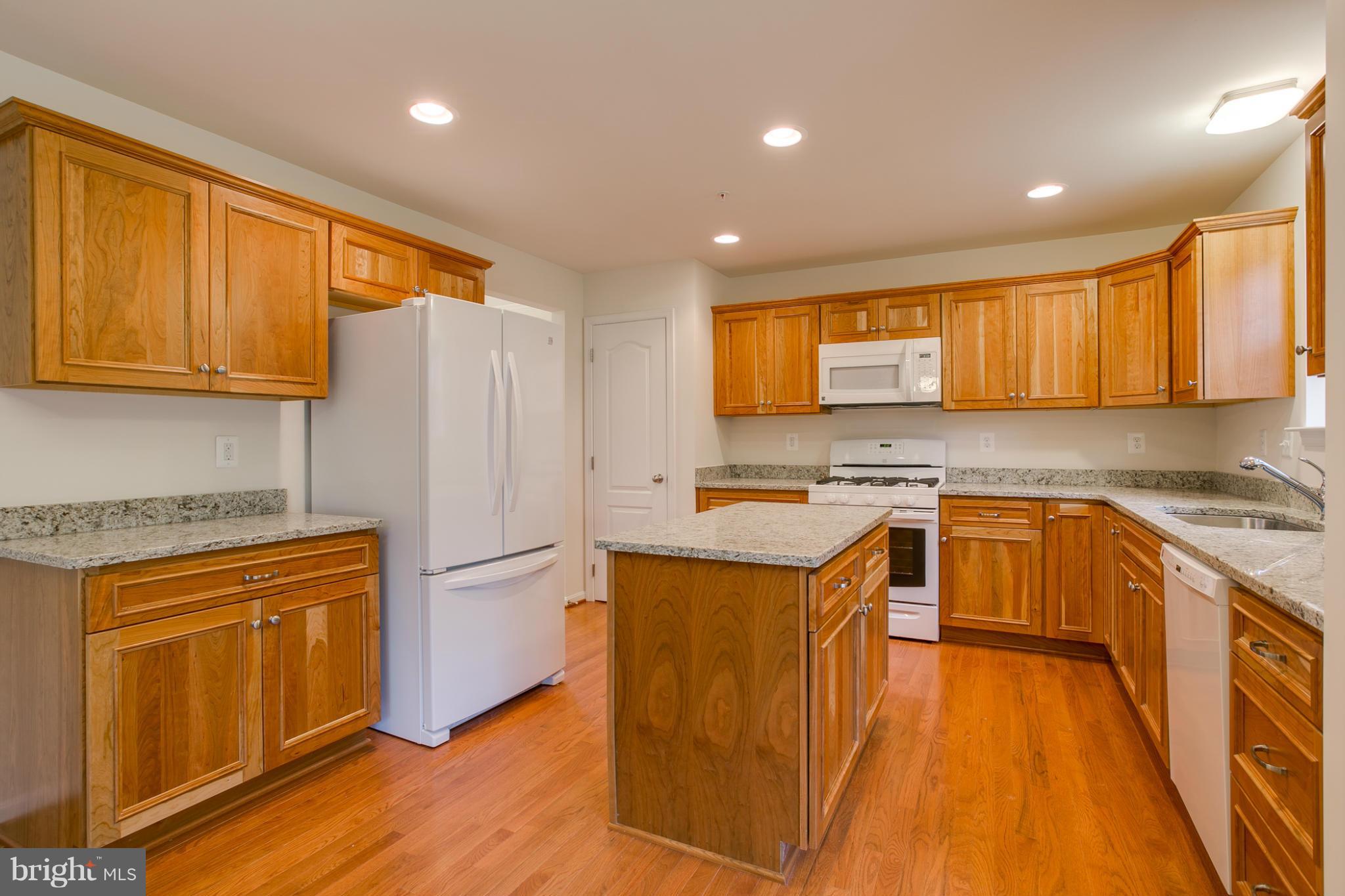 4 Hanover Road Hanover, MD 21076 - Photo 4 of 30 a kitchen with stainless steel appliances granite countertop a stove a sink dishwasher and a refrigerator with wooden floor