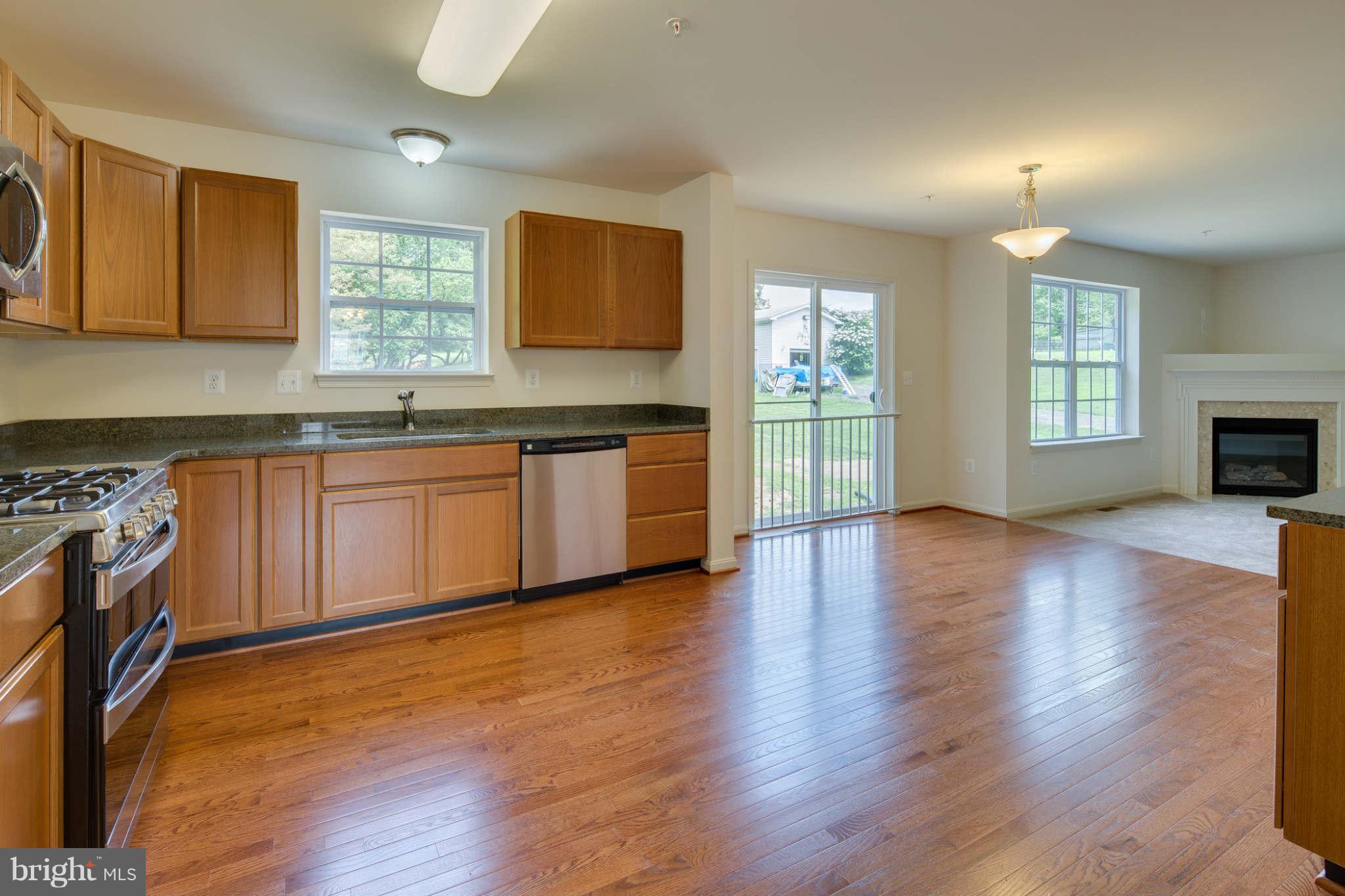 4 Hanover Road Hanover, MD 21076 - Photo 6 of 30 a large kitchen with wooden floors and stainless steel appliances