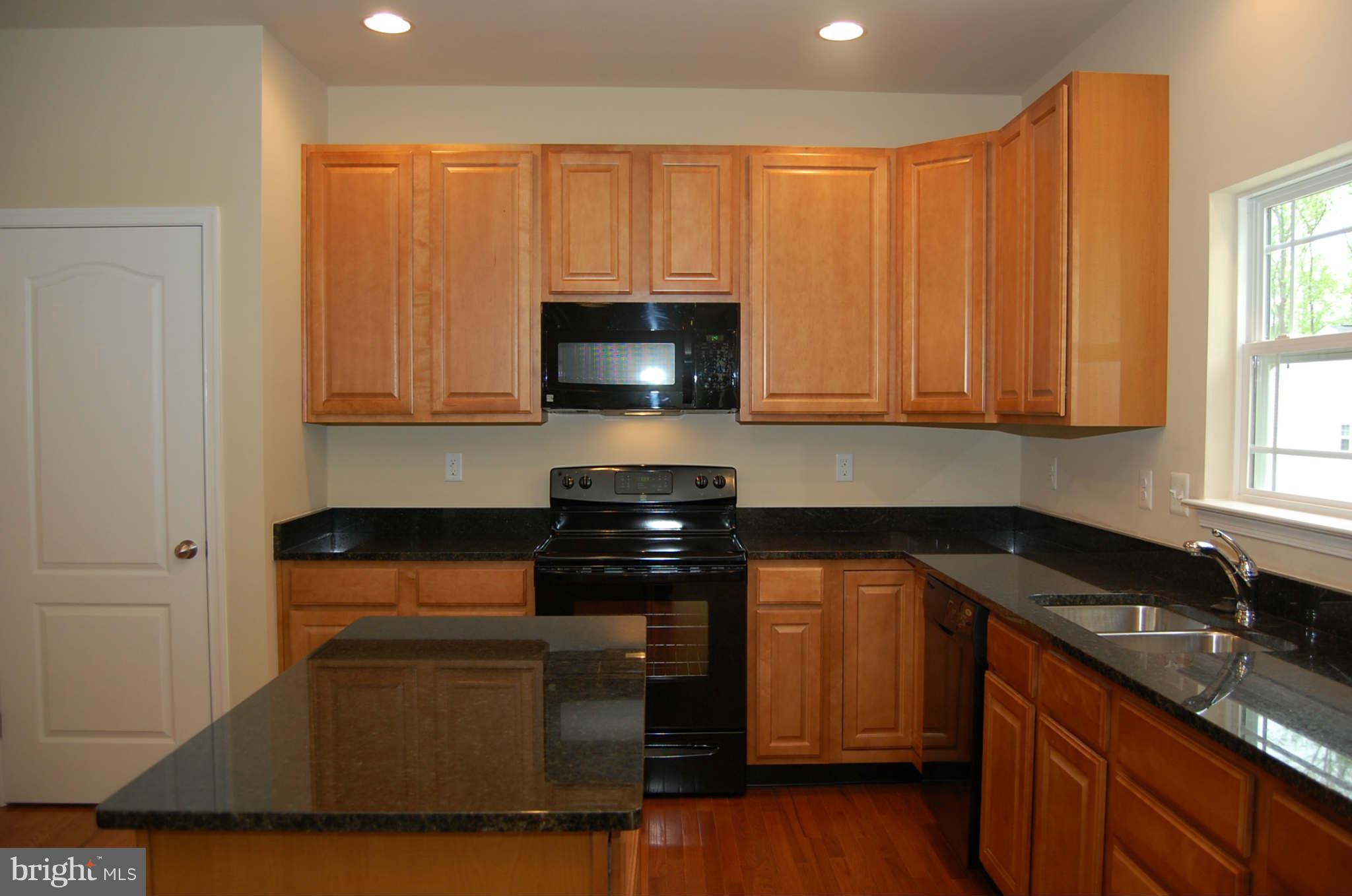 4 Hanover Road Hanover, MD 21076 - Photo 9 of 30 a kitchen with stainless steel appliances granite countertop a stove a sink and a microwave