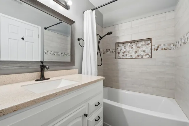 a bathroom with a bathtub and shower