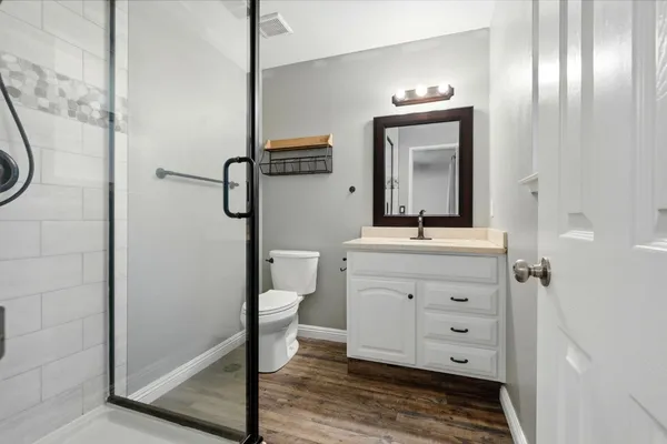 a bathroom with a toilet a sink and mirror