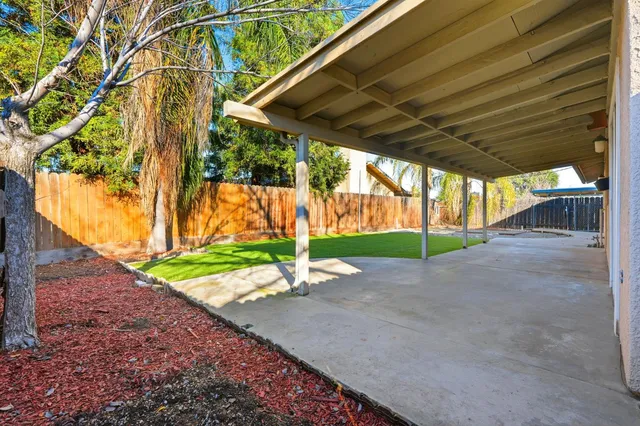 a view of a yard with wooden fence