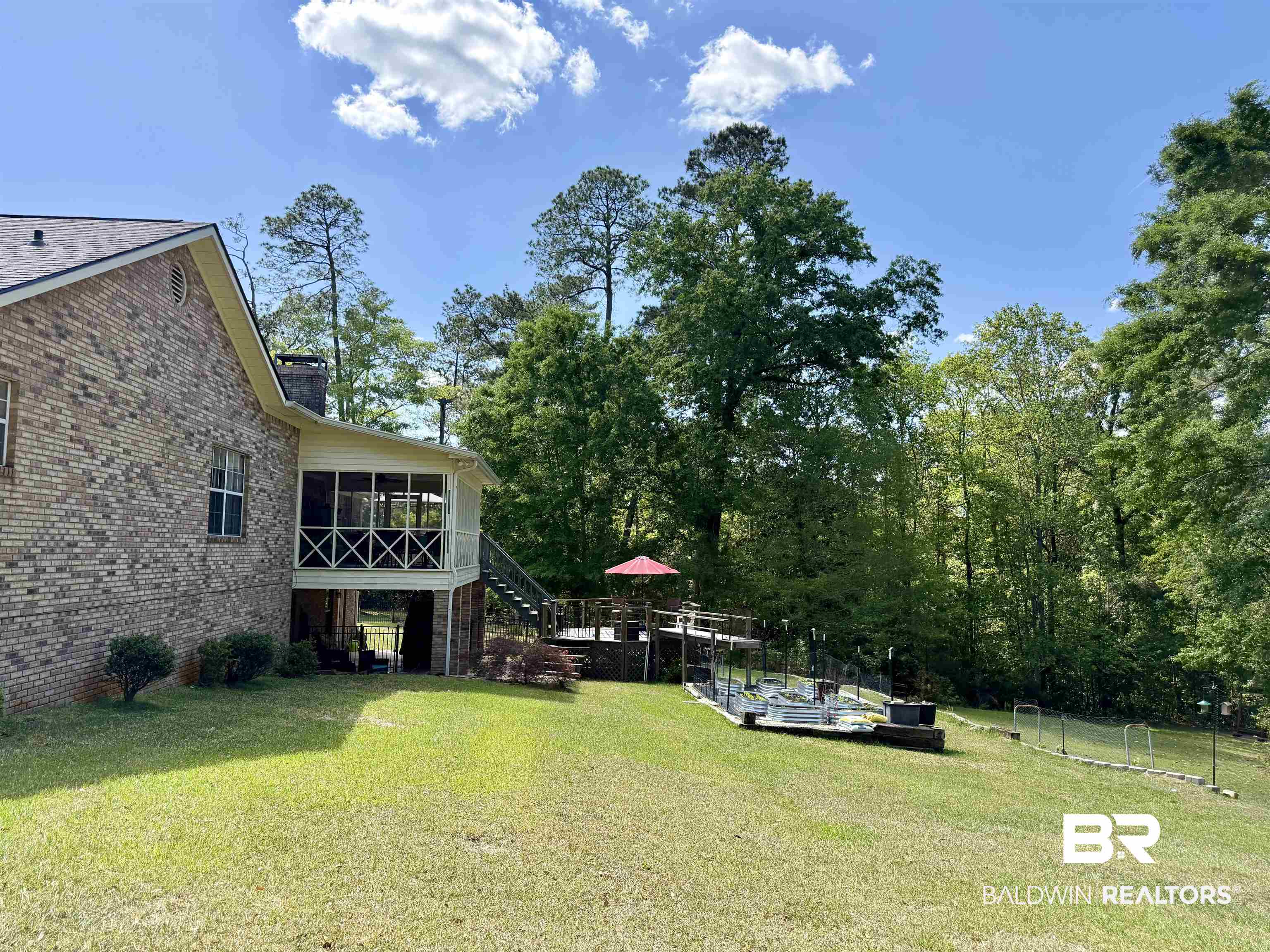 2944 Appleton Road Brewton, AL 36426 - Photo 59 of 65 View of grassy yard featuring a sunroom and view of wooded area