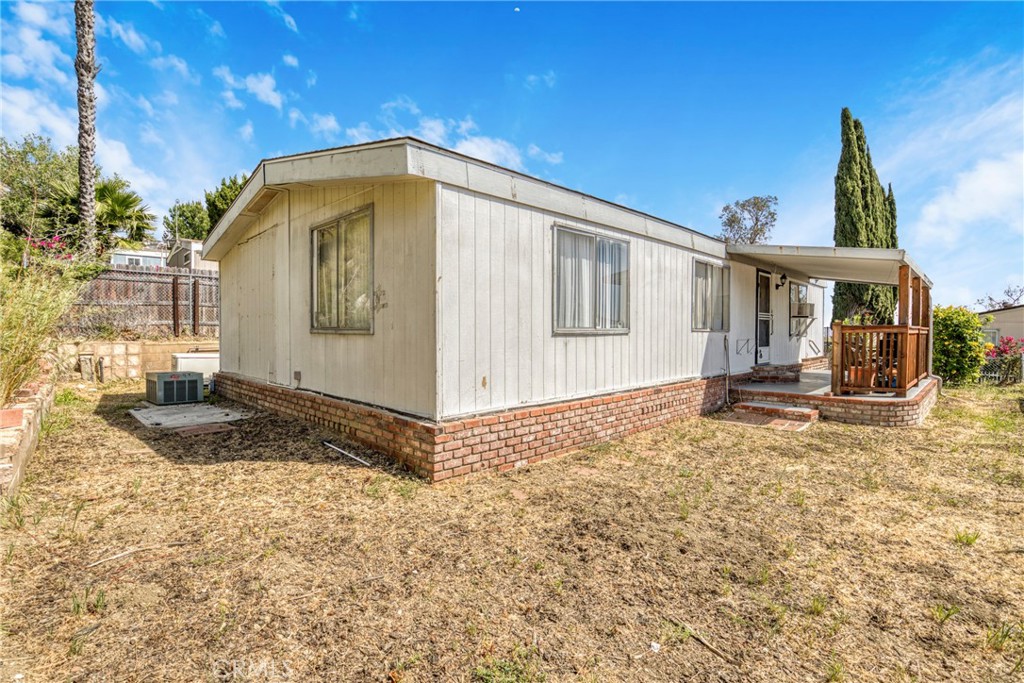 24425 Woolsey Canyon Road, Unit 5 West Hills, CA 91304 - Photo 12 of 17 a front view of a house with a yard