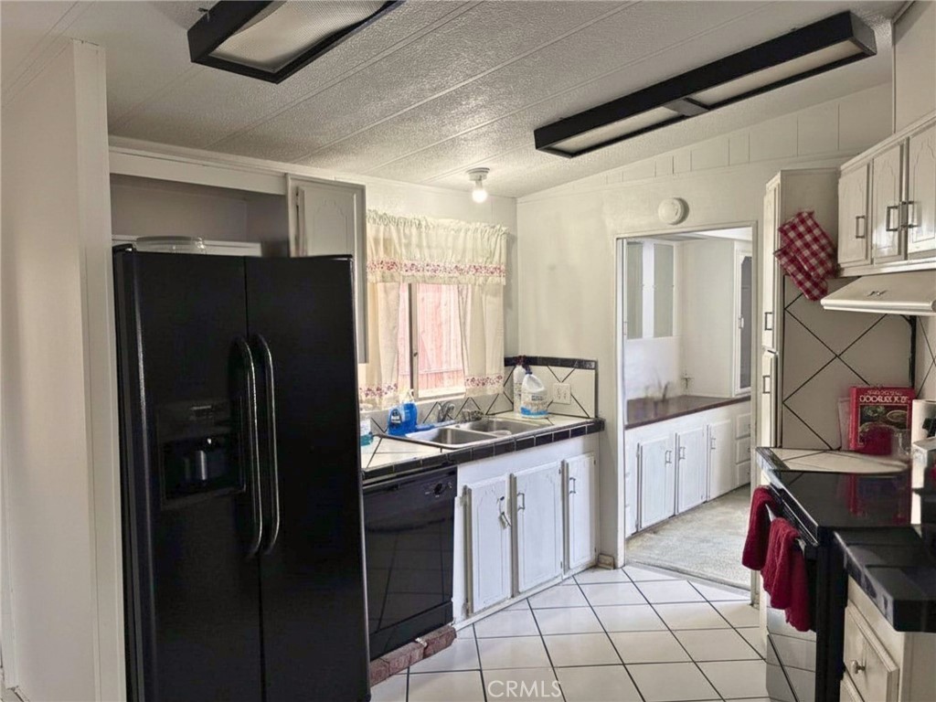 24425 Woolsey Canyon Road, Unit 5 West Hills, CA 91304 - Photo 17 of 17 a kitchen with a sink appliances and cabinets