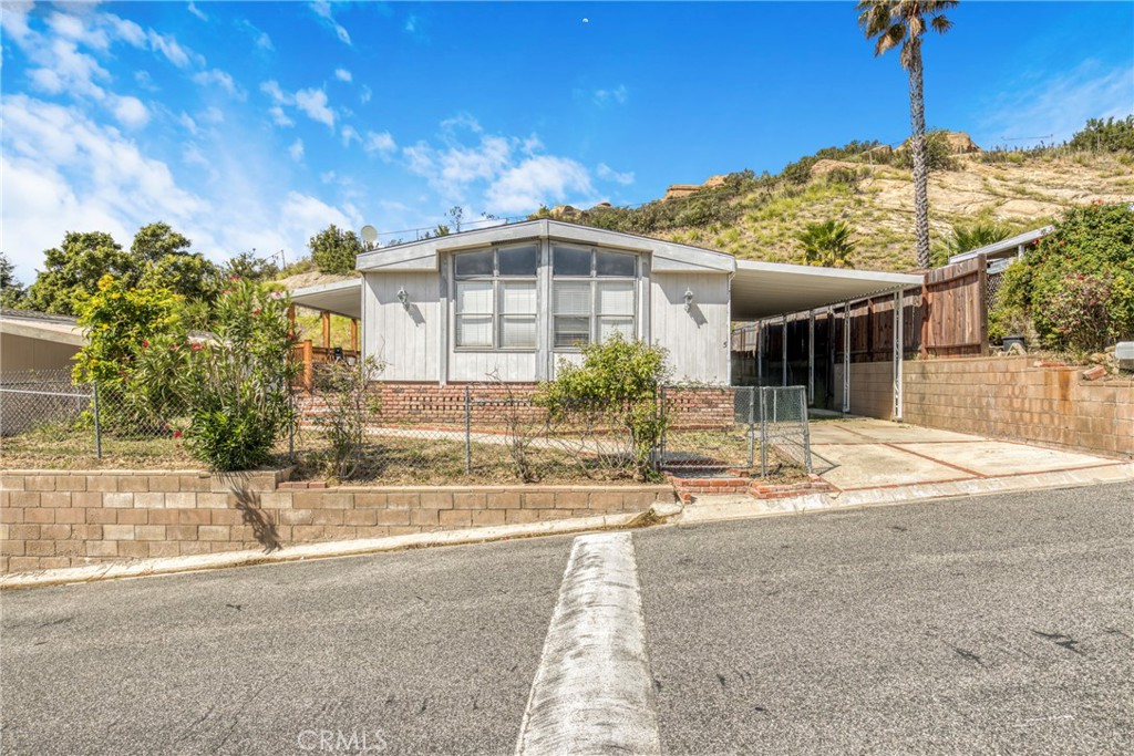 24425 Woolsey Canyon Road, Unit 5 West Hills, CA 91304 - Photo 2 of 17 a front view of a house with a yard