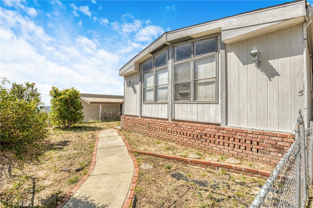 24425 Woolsey Canyon Road, Unit 5 West Hills, CA 91304 - Photo 8 of 17 a front view of a house with a yard