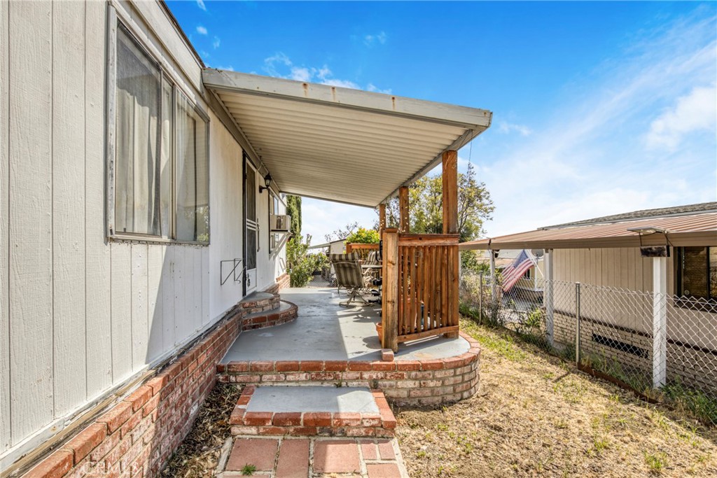 24425 Woolsey Canyon Road, Unit 5 West Hills, CA 91304 - Photo 9 of 17 a view of a balcony with chair and wooden floor