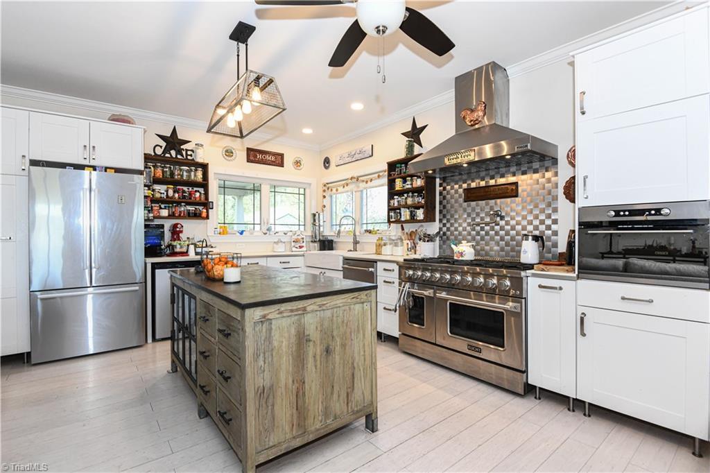 7164 Ludgate Road Gibsonville, NC 27249 - Photo 10 of 50 Kitchen with prof 8 burner stove and soapstone island