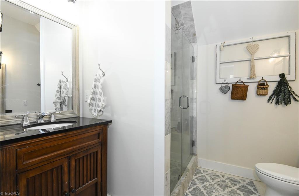 7164 Ludgate Road Gibsonville, NC 27249 - Photo 22 of 50 ensuite bath has two counters with granite tops