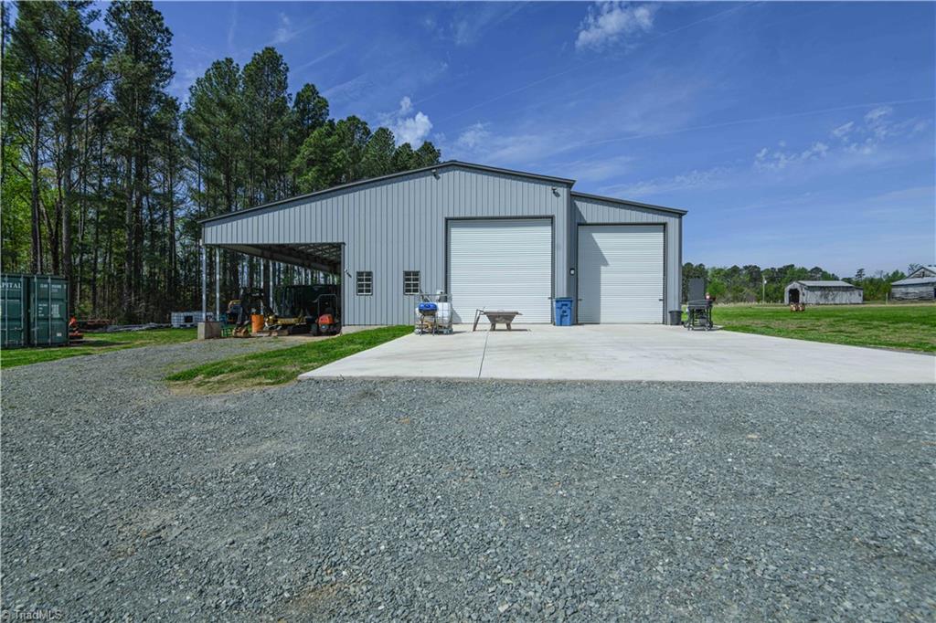 7164 Ludgate Road Gibsonville, NC 27249 - Photo 29 of 50 50x65 metal building garage doors on both sides. Can garage your RV on right. Store farm equipment on left.