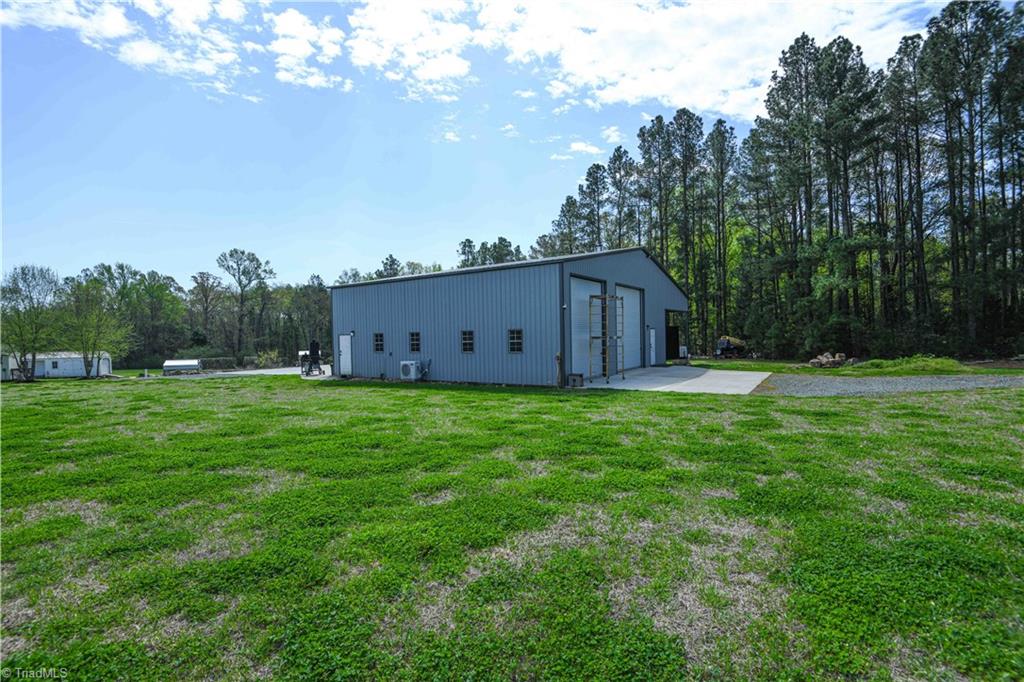 7164 Ludgate Road Gibsonville, NC 27249 - Photo 41 of 50 Back of metal building with garage openings