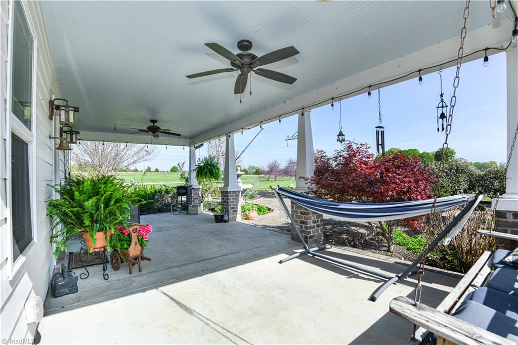 7164 Ludgate Road Gibsonville, NC 27249 - Photo 6 of 50 Covered porch - view from far side