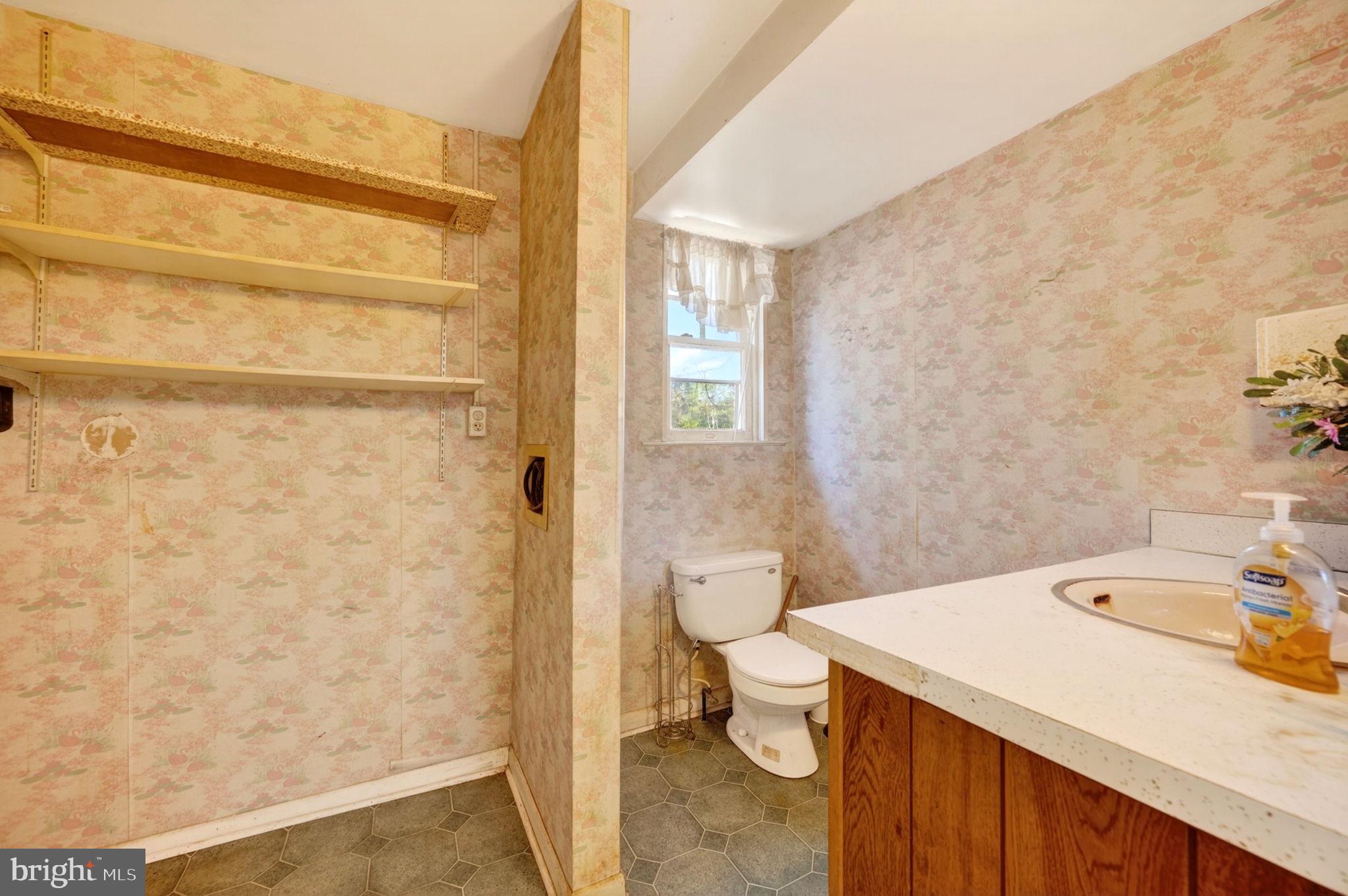 131 Midland Road Glen Burnie, MD 21060 - Photo 13 of 44 a bathroom with a sink a toilet and shower