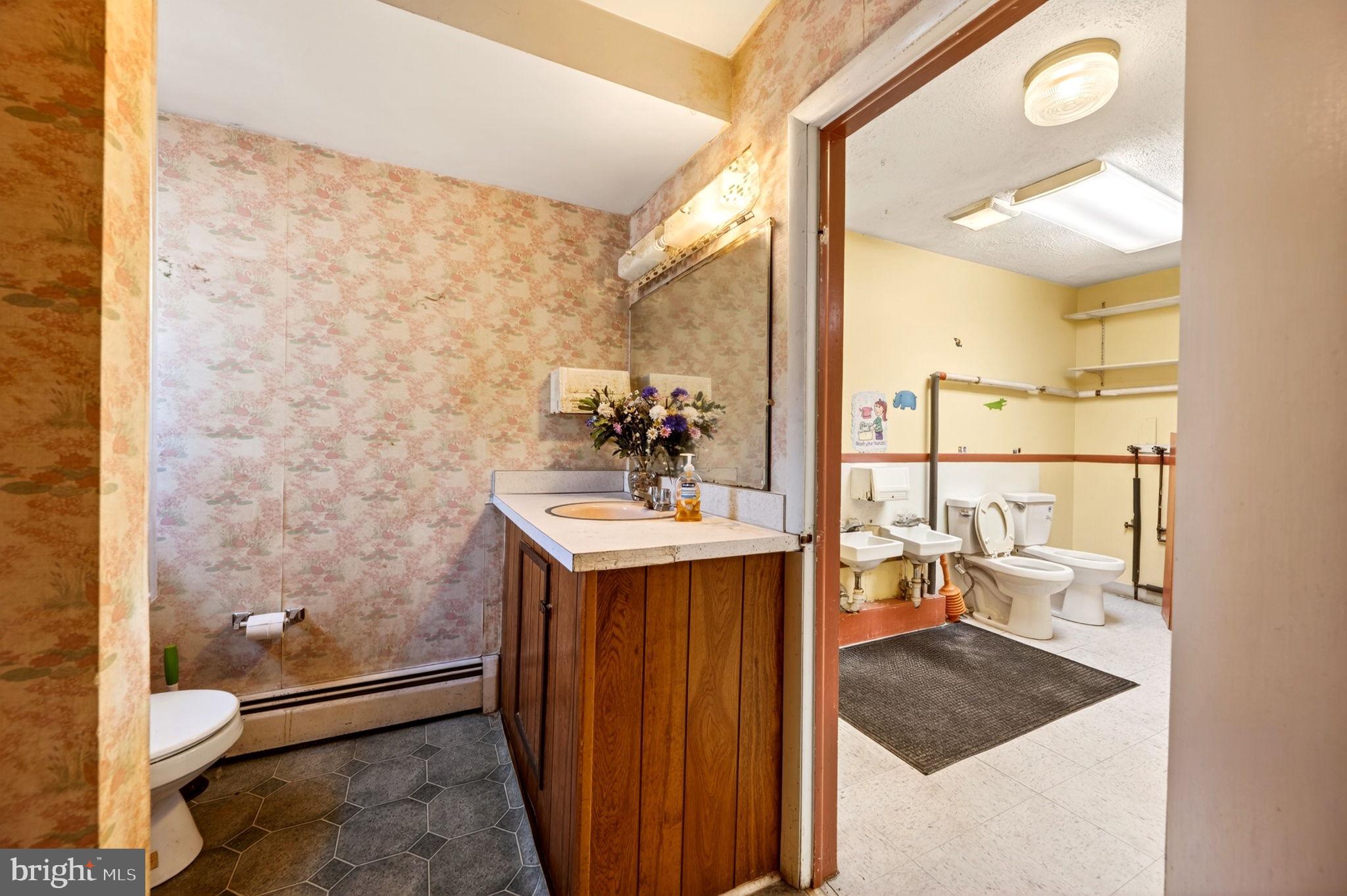 131 Midland Road Glen Burnie, MD 21060 - Photo 14 of 44 a bathroom with a sink a toilet and mirror