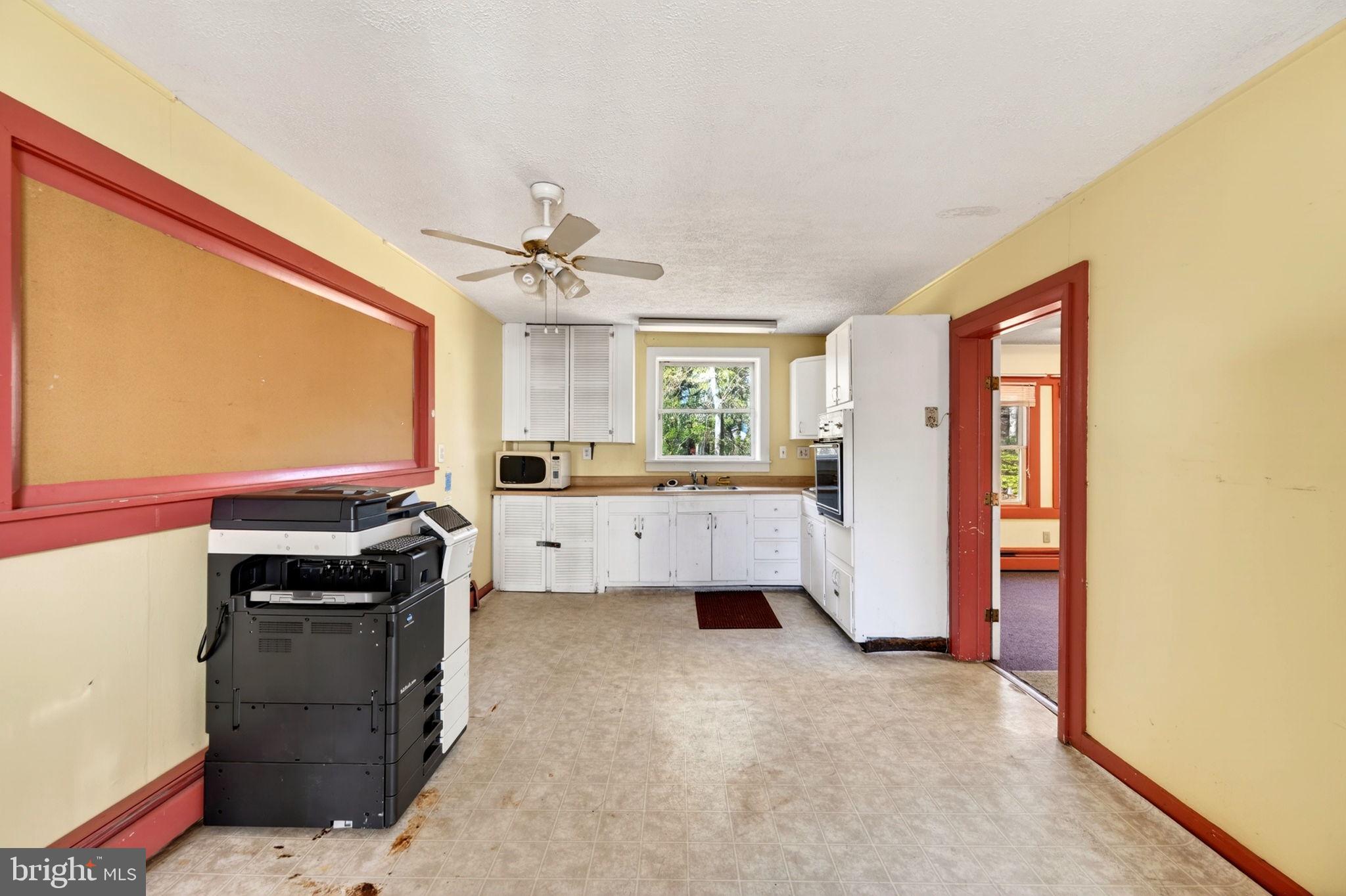 131 Midland Road Glen Burnie, MD 21060 - Photo 17 of 44 a kitchen with a stove a sink and a refrigerator