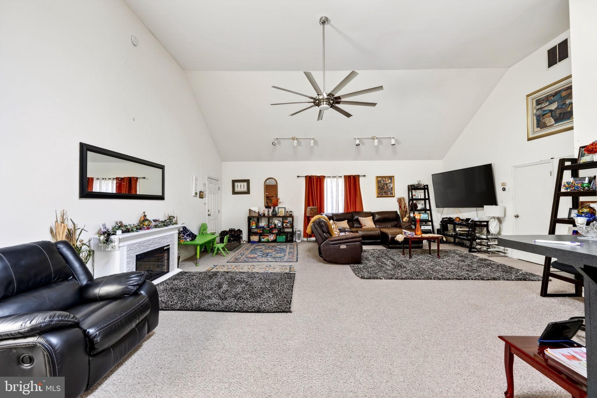 131 Midland Road Glen Burnie, MD 21060 - Photo 22 of 44 a living room with furniture a flat screen tv and a fireplace